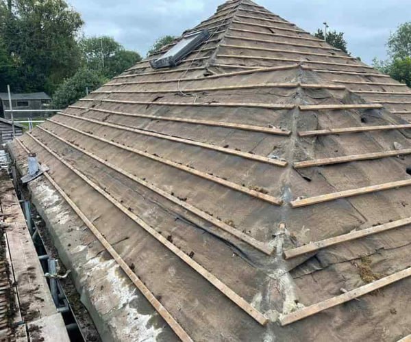 This is a photo of a hip roof that has been stripped back to the battens, and is awaiting a new roof covering to be installed. Works carried out by NGF Roofing Brixworth